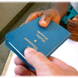 A student receiving the Gideons Bible as a donation